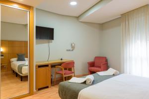 Postel nebo postele na pokoji v ubytování Hotel Alda Xinzo