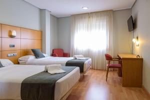 Postel nebo postele na pokoji v ubytování Hotel Alda Xinzo