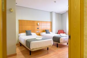 Postel nebo postele na pokoji v ubytování Hotel Alda Xinzo