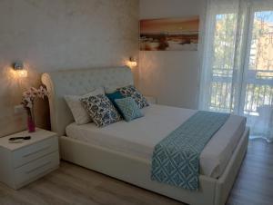 a bedroom with a white bed with pillows at Viola di Mare Rooms and Parking in Termoli