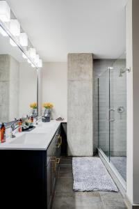a bathroom with two sinks and a shower at Sable 501 - Luxury Two Story Loft in Minneapolis