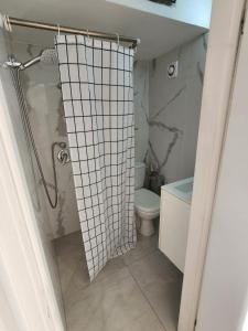 a bathroom with a shower with a toilet and a sink at Premium 2BR Sea View Apartment Bat Yam in Bat Yam