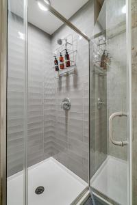 a shower with a glass door in a bathroom at Sable 606 - One Bedroom in Minneapolis +25 photos