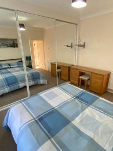 a bedroom with a bed and a large mirror at 200A Ringwood Road in Poole