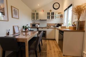 a kitchen with a wooden table and a dining room at La Maisonnette - Disneyland Paris in Chanteloup-en-Brie