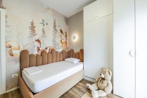 a bedroom with a bed with a teddy bear at Chloe's Central Apartment in Durrës