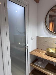 a bathroom with a sink and a mirror at Nashos Bungalows in (( Spile ))