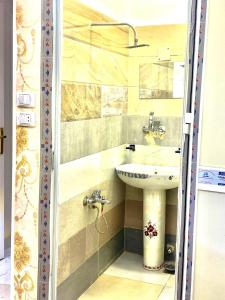 a bathroom with a sink and two faucets at sphinx one centre hotel in Cairo