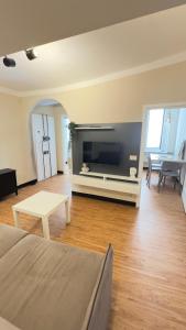 a living room with a couch and a tv at La CASA del PORTO ANTICO in Genoa
