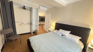 a bedroom with a bed and a chair in it at La CASA del PORTO ANTICO in Genoa