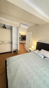 a bedroom with a large bed and a living room at La CASA del PORTO ANTICO in Genoa +29 photos