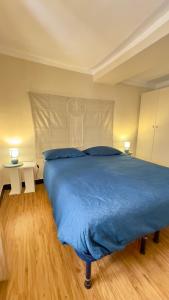 a bedroom with a bed with a blue blanket at La CASA del PORTO ANTICO in Genoa