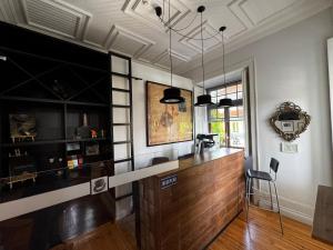 a room with a bar with a wooden counter at Penedo da Saudade Suites & Hostel in Coimbra