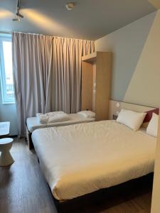 Posteľ alebo postele v izbe v ubytovaní ibis budget Nancy Laxou