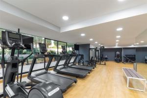 a gym with a row of treadmills and ellipticals at NH Collection Mexico City Reforma in Mexico City +70 photos