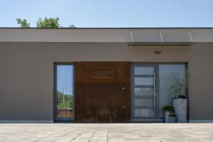 a building with a door with a sign on it at Villa Veros for 5 people near Labin - Rabac with private pool & kids playground in Labin