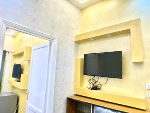 a flat screen tv on a wall in a room at sphinx one centre hotel in Cairo +42 photos