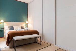 a bedroom with a bed and a chair in it at Alohamundi Chicarreros Catedral in Seville