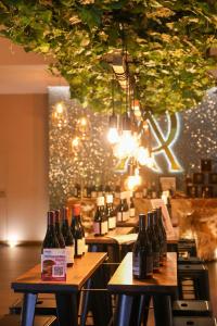 a bunch of bottles of wine on tables in a restaurant at Quinta da Atela in Alpiarça