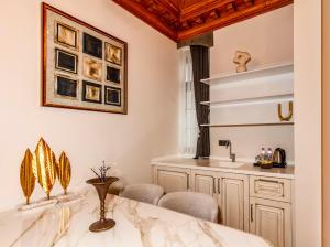 a bathroom with a sink and a counter with chairs at Elmira Pera Hotel & - Special Class in Istanbul +96 photos