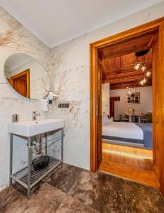 a bathroom with a sink and a bed in a room at Elmira Pera Hotel & - Special Class in Istanbul
