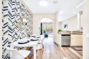 a kitchen with a white table and white chairs at 2BR Queen bed Condo - Hot Tub Pool - Near Disney in Orlando +24 photos