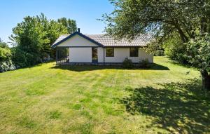 a small white house on a grassy field at Holiday Home Solbakken Odder Vi in Odder +13 photos