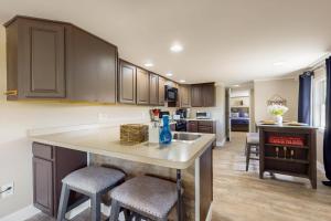 a kitchen with a island in the middle of a room at The Apartment at the Compound in Fort Ann