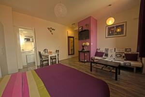 a bedroom with a colorful bed and a table at Studio Dolac Centar in Zagreb