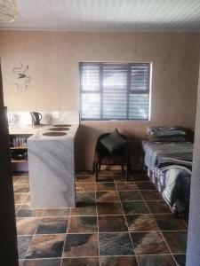 a kitchen with a counter in a room with a bed at Dreams in Vryheid +10 photos