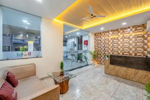 a living room with a couch and a table at Basotel Hotel Indore Vijaynagar in Indore