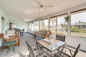 un porche cubierto con mesa y sillas en Englewood Home on Canal Boat to Lemon Bay!, en Englewood