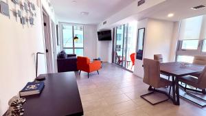 a living room with a dining room table and chairs at Sky-High oasis heated Pool & Gym Miami Skyline Vista in Miami +54 photos