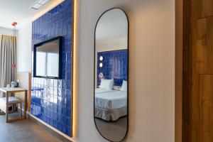 a mirror in a room with a bed at Perla Marina in Nerja
