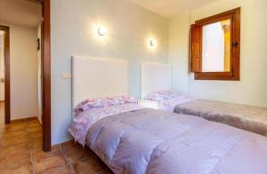 a bedroom with two beds and a window at Elegant Penthouse with Private Rooftop Punta Prima in Torrevieja