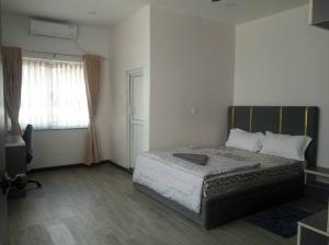 a bedroom with a bed and a window at Buddha Palm Retreat in Chitwan +5 photos