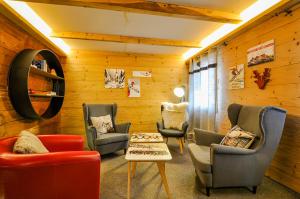 a waiting room with chairs and a table and a mirror at Chalet La Scie in Morgins