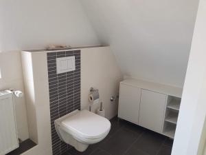 a small bathroom with a toilet and a sink at FeWo Overberge in Bergkamen