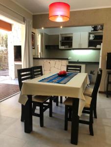 a kitchen and dining room with a table and chairs at Valeria Beach in Valeria del Mar +7 photos
