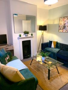 a living room with a couch and a table at The Velveteen Townhouse in Colchester