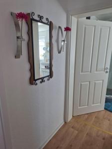 a mirror on a wall next to a door at Picco 2 in Beuren
