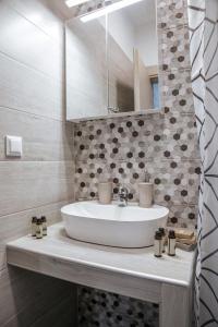 a bathroom with a sink and a mirror at Villa Platania in Stavros +15 photos