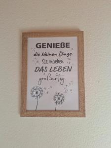 a framed picture of a sign on a wall at Bauernhof Urlaub FeWo Nr 3 - 5-Personen in Schlagsdorf