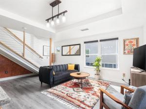 a living room with a couch and a table at Anastasia Island Villa Upper Level plus Rooftop in St. Augustine +43 photos