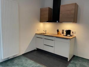 a kitchen with a sink and a counter top at PAULINEN Residenz Komfortabel wohnen - Flexibel ankommen in Detmold +25 photos