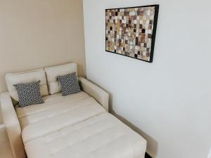 un sofá blanco en una habitación con una foto en la pared en Apartamento charmoso no Rio, en Río de Janeiro