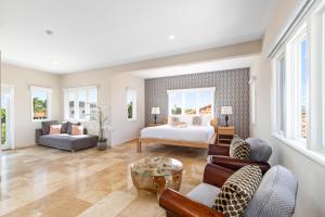 a living room with a bed and a couch at Upscale Ocean View Villa with Pool Outdoor Kitchen in Palm-Eagle Beach +91 photos