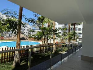 a balcony with a view of a pool and buildings at Apartamento Playa Granada Golf in Motril