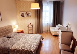 a bedroom with a bed and a couch and a table at Lux-Apartment in Medieval Part of Old Riga in Riga