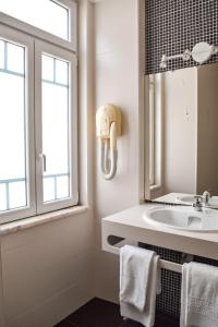 a bathroom with a sink and a mirror at Residência Maciel in Peniche +89 photos